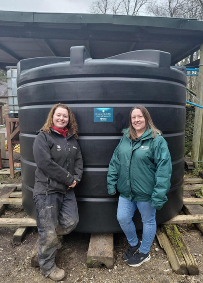 People posed with water tank